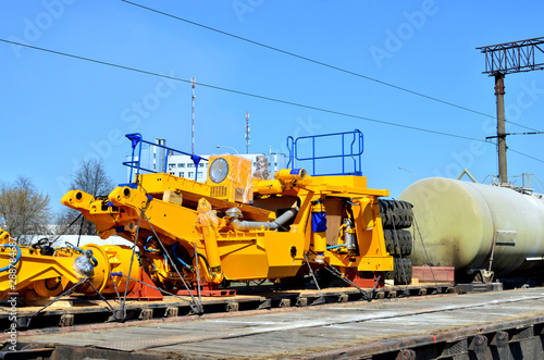 Logistics transportation heavy mining dump truck by rail. Yellow mining truck disassembled into parts, cab, body, electric motor, drive, wheels, loaded onto a cargo railway platform. - Image