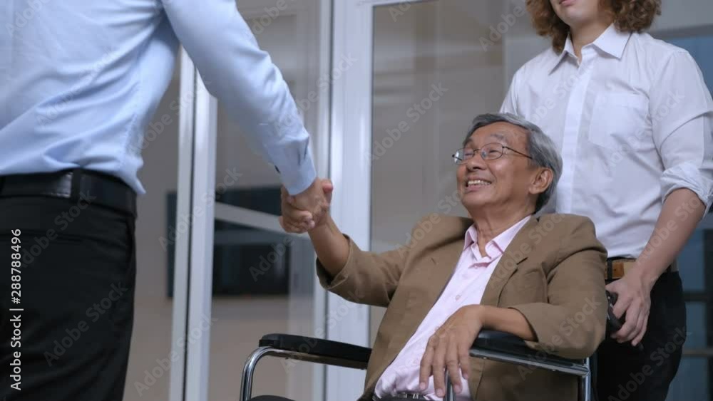 Health concept. The doctor is holding hands with the patient sitting on a wheelchair. 4k Resolution. Health concept. The doctor is holding hands with the patient sitting on a wheelchair. 4k Resolution.