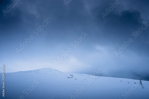 Snow covered Storsteinen mountain summit