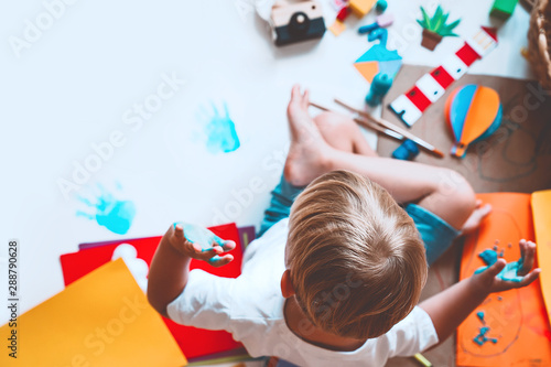 Kids draw and make crafts. Kindergarten or preschool background.