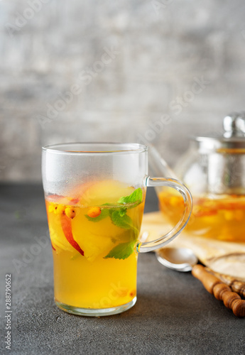 A glass of fruit tea on grey background