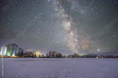 Frozen lake in winter against the background of the starry sky