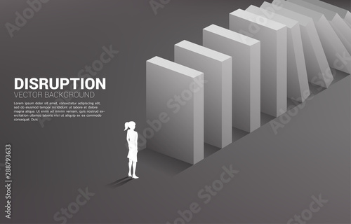 Silhouette of businesswoman standing at the end of domino collapse. Concept of business industry disrupt