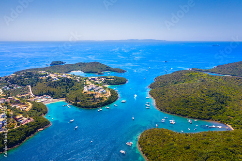 Aerial view of iconic paradise sandy beaches with turquoise sea in complex islands of Agios Nikolaos and Mourtos in Sivota area, Epirus, Greece photo