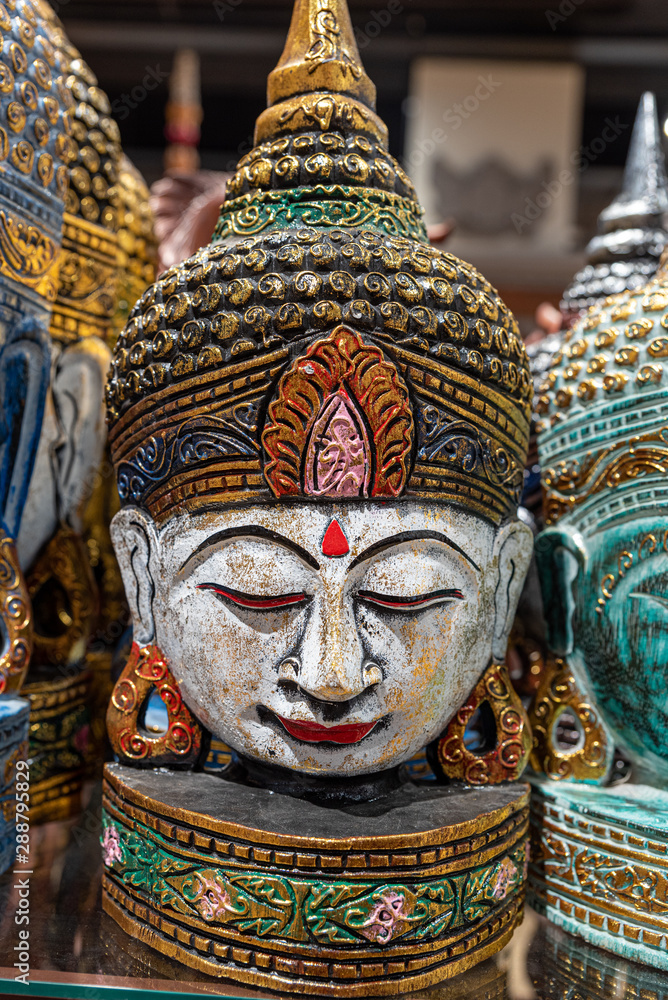 balinese head buddha statues on a shelf