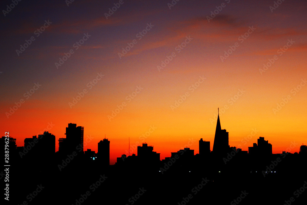 Sunrise with city silhouette showing the buildings and the catheral in Maringa, Parana, Brazil