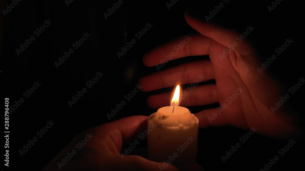 Concept of appeasement, concentration, religion. Believer holding a candle. Believers seeking the salvation of souls in the dark Concept of appeasement, concentration, religion. Believer holding a candle. Believers seeking the salvation of souls in the dark