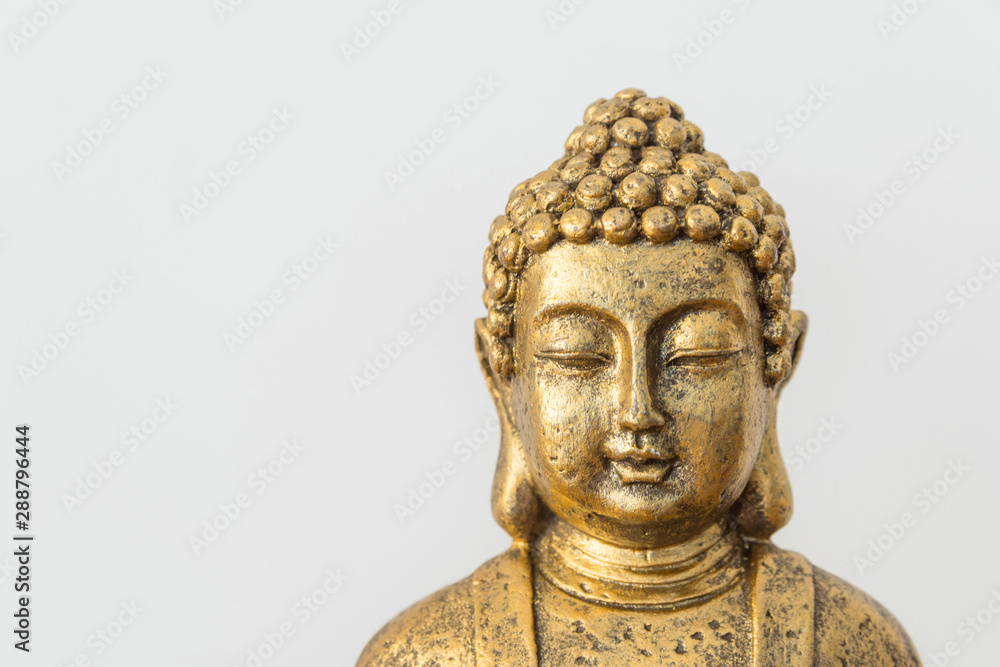 Generic golden statue of Buddha on white wall background. Interior decoration accessories abstract concept of balance zen meditation harmony. Inspirational poster with copy space