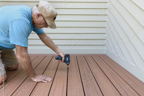 Builder Installing New Composite Wood Deck