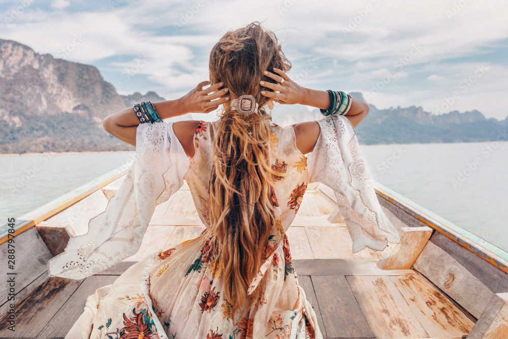 fashionable young model in boho style dress on boat at the lake - obrazy, fototapety, plakaty 