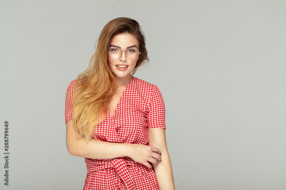 Ginger girl with freckles posing in studio, emotions. Ginger girl with freckles posing in studio, emotions.