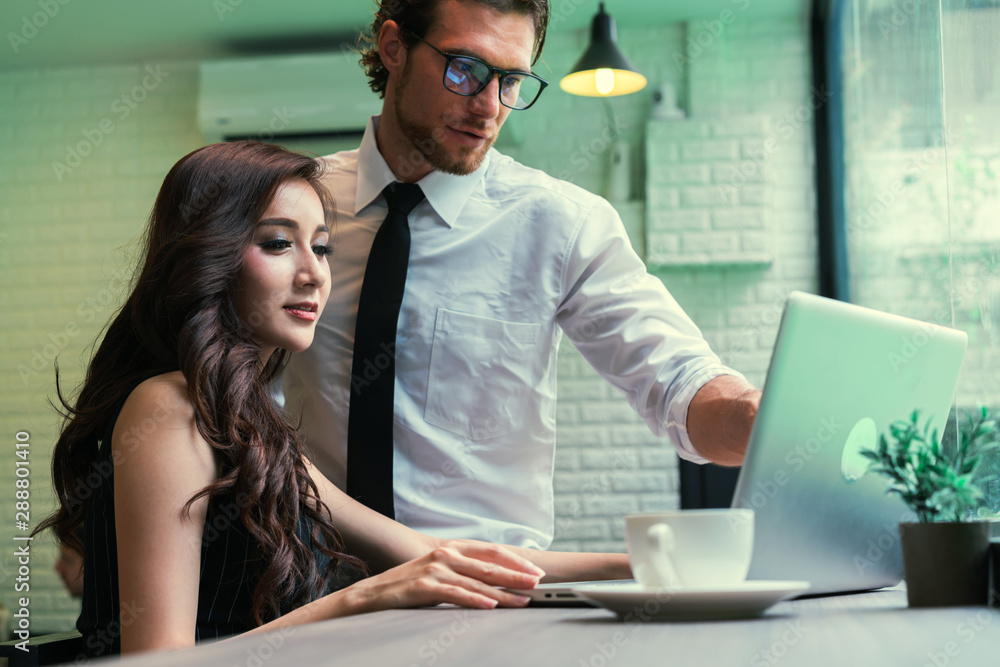 Fototapeta premium Businessman and businesswoman casual meeting together. Asian woman using laptop present and sharing business idea. concept of business, education, finance and thinking.