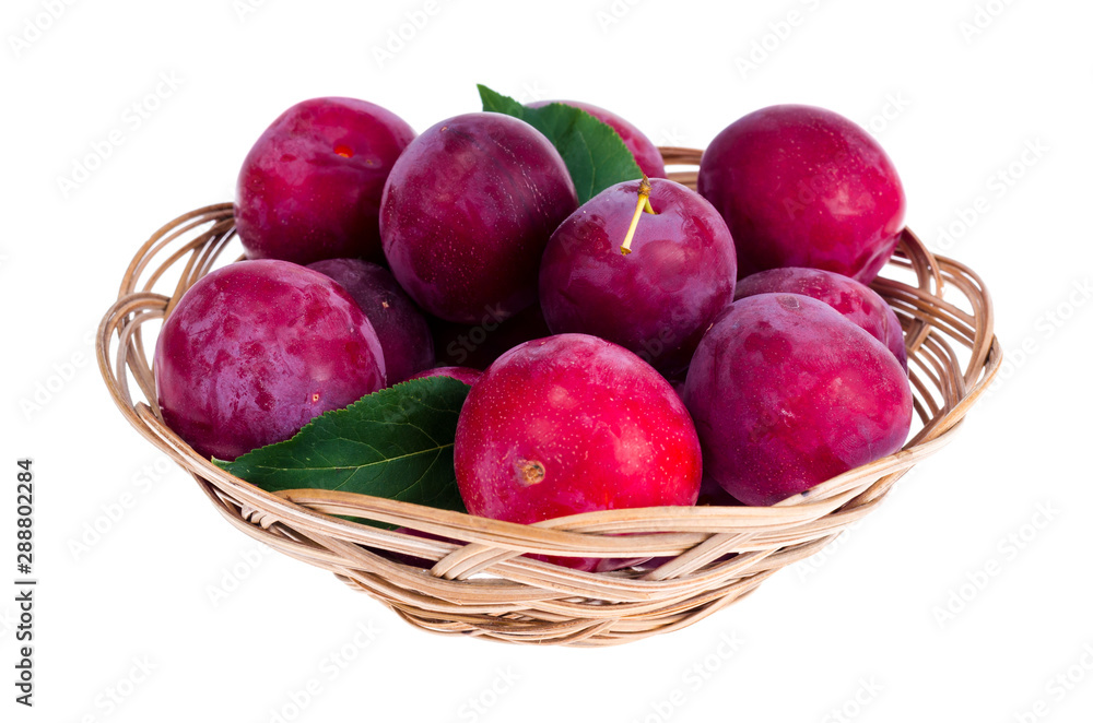 Ripe sweet plums in wicker bowl. Photo Ripe sweet plums in wicker bowl. Photo