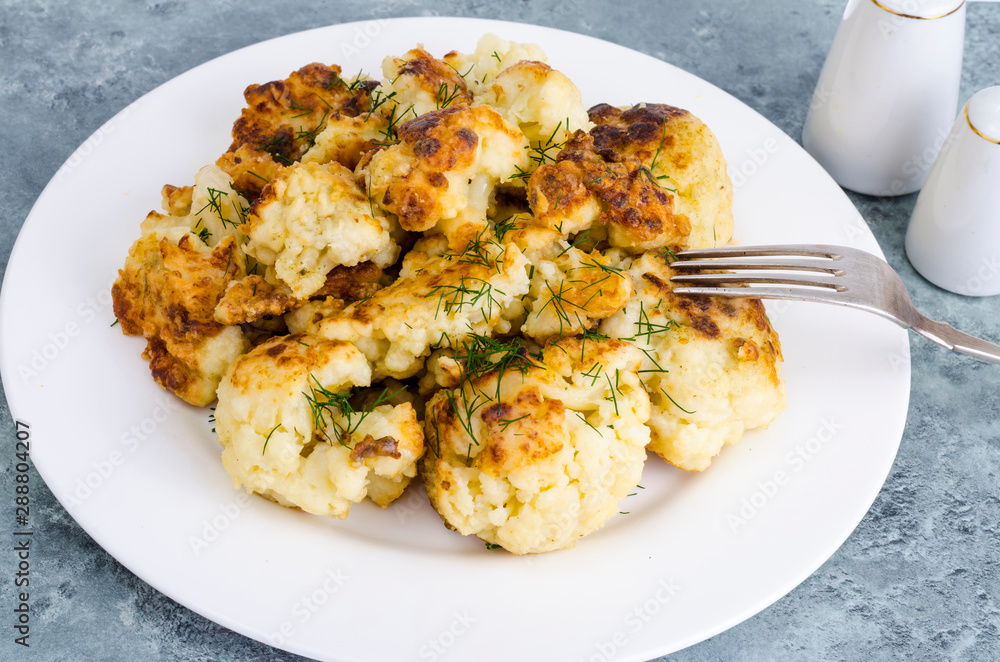 Fried cauliflower in batter on white plate Fried cauliflower in batter on white plate
