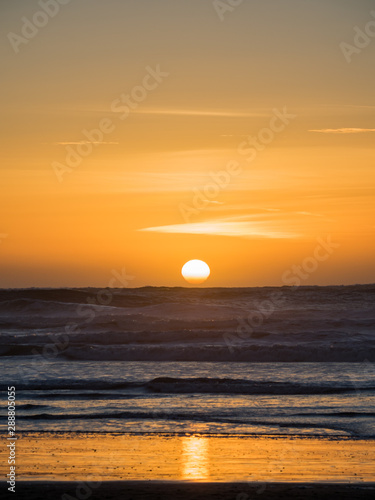 Fototapeta Naklejka Na Ścianę i Meble -  Sunset over the Ocean, Orange Sky and Dark Blue Waves, Pacific Ocean