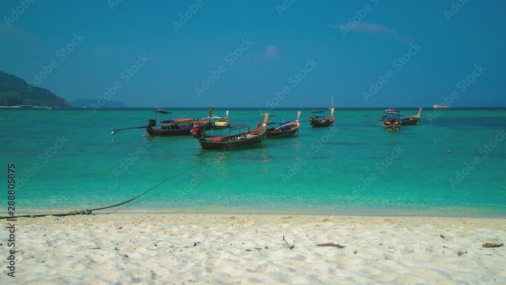A beautiful 4K UHD Cinemagraph of a tropic seaside beach at Koh Lipe, Thailand with traditional long tail boats. A beautiful 4K UHD Cinemagraph of a tropic seaside beach at Koh Lipe, Thailand with traditional long tail boats.