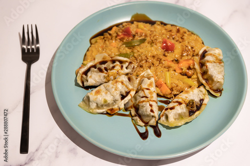 spicy vegetable risotto with vegan dumplings and soy sauce