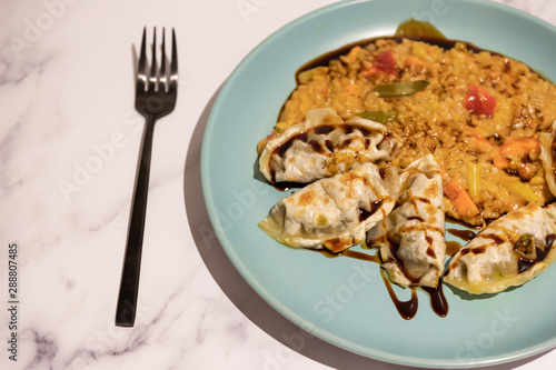 spicy vegetable risotto with vegan dumplings and soy sauce