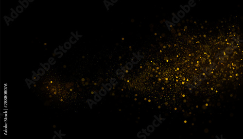 Golden glitter dust on black background