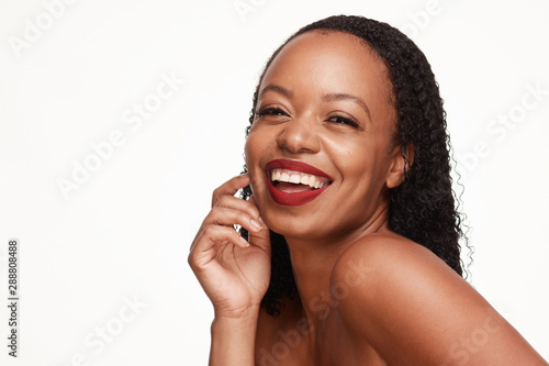 Gorgeous smiling young fresh faced African American woman, beautiful long textured hair