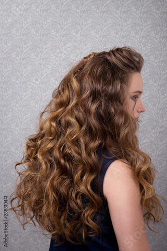 Female hairstyle long curls close-up rear view.