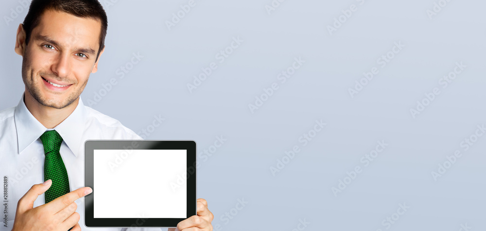 Businessman showing blank tablet pc, with copy space Businessman showing blank tablet pc, with copy space
