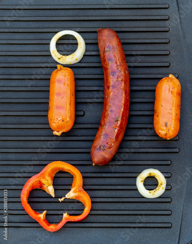 Three sausages on a grill