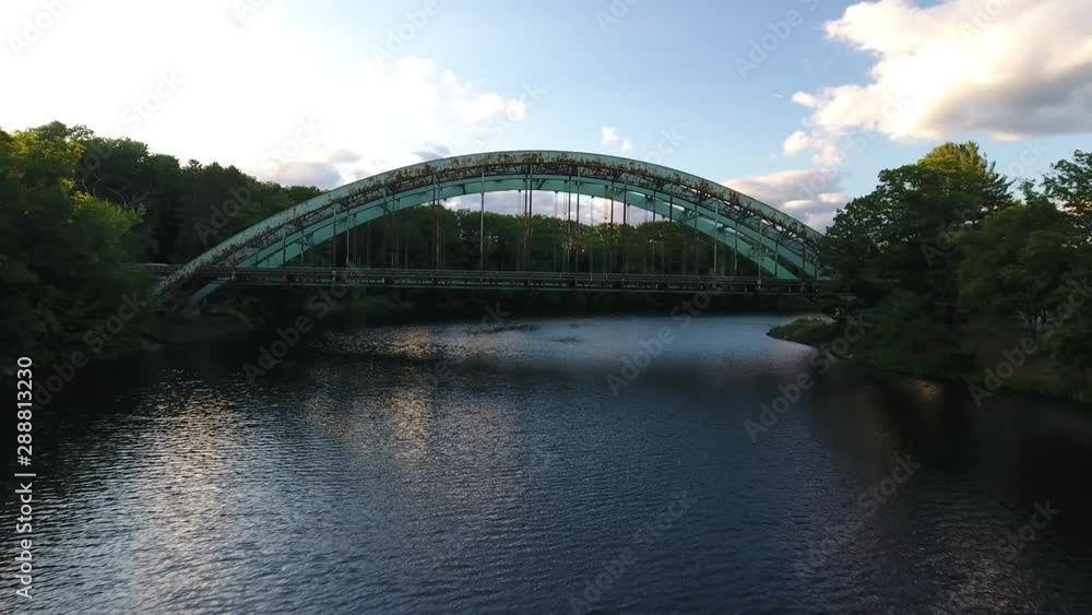 Aerial Video Push In towards Steel Arch Bridges over River between Forested Banks Aerial Video Push In towards Steel Arch Bridges over River between Forested Banks