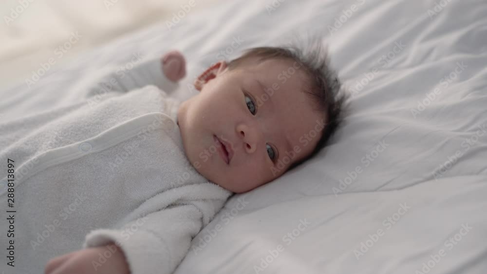 cute little infant newborn baby on white bed cute little infant newborn baby on white bed