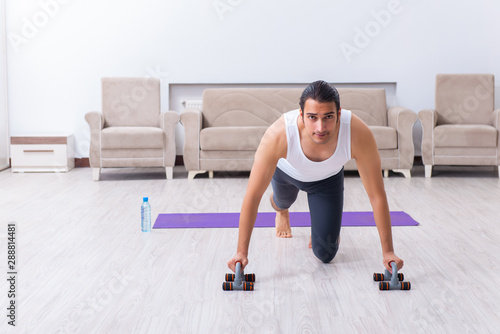 Young man training and exercising at home