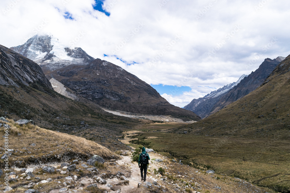 Unidentified backpacker walking through the mountains of Huascaran National Park, on the way to Lake 69, Peru