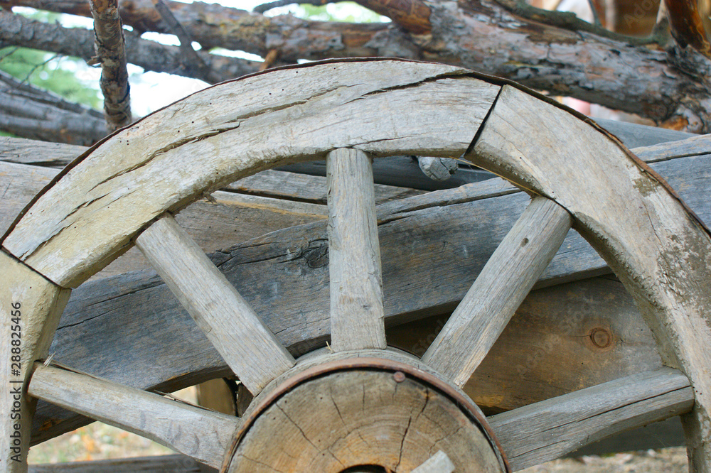 fragment of the old (vintage) wooden wheel. 19th century wagon wooden wheel. antique metal parts made in the forge