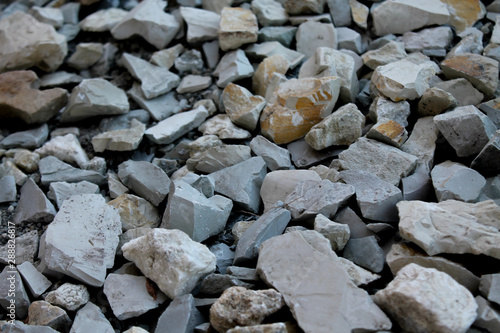 Abstract background with gray rocks. Sharp stones on the ground. Textured rocky backdrop with copy space for text