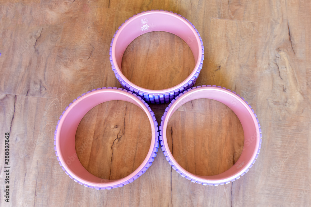 All kinds of Yoga props are on the wooden floor of the yoga studio. Conveyor belts, mats and cushion blocks are in the yoga center. The concept of health activities