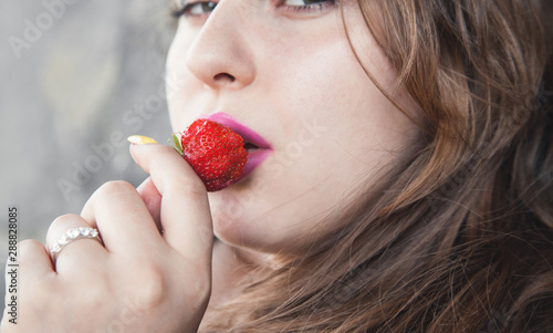 Woman eating fresh strawberry. Health, Diet