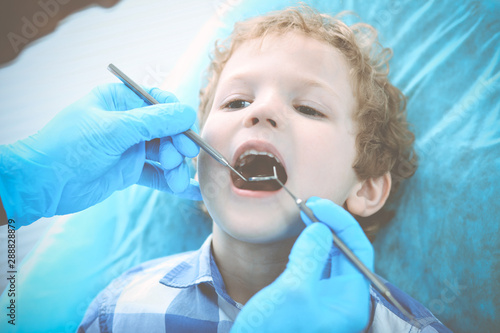 Doctor and patient child. Boy having his teeth examined with dentist. Medicine  health care and stomatology concept