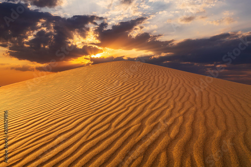 Sunset over the sand dunes in the desert