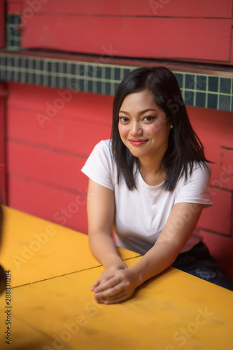 Asian woman smiling with perfect smile in a park and looking at camera