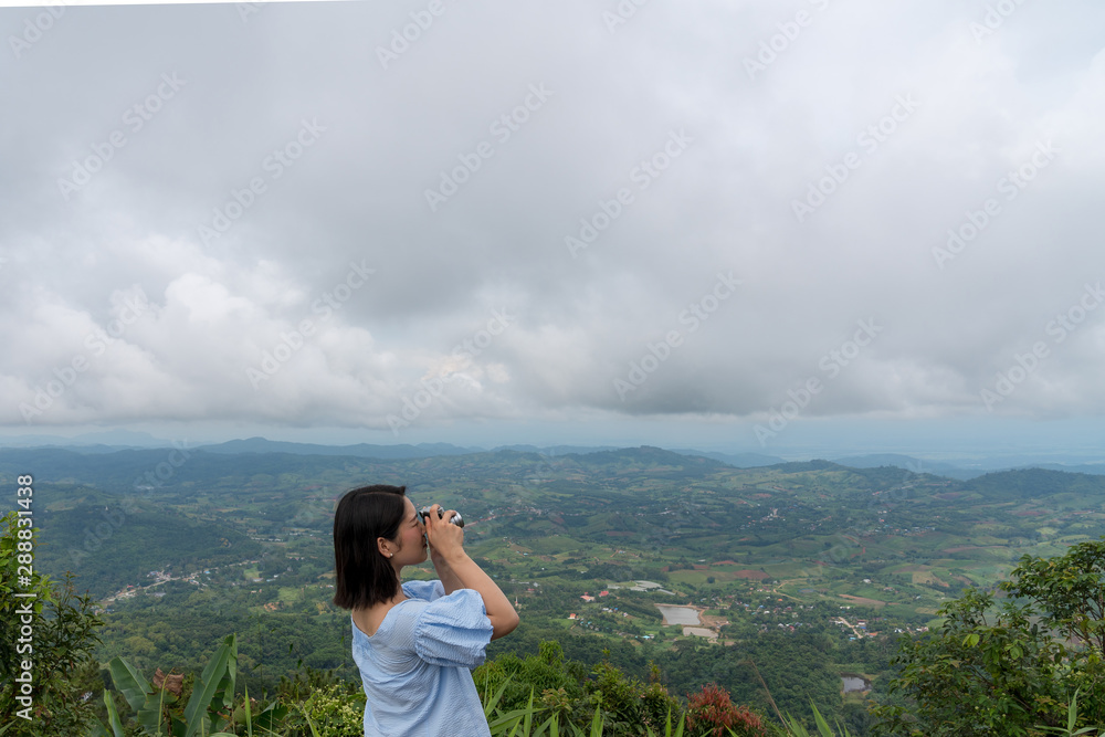 young cute Japanese Asian hipster girl travelling at beautiful sky  mountains scenery park hiking garden views at Kanchanaburi Thailand guiding  idea for female backpacker woman women backpacking