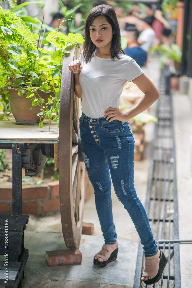 Asian attractive young woman with magnificent long hair posing outdoor. Beauty, fashion concept.