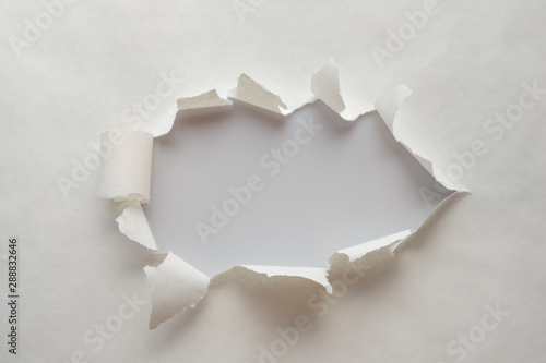 A hole in old paper with the sides torn off. with space for your message