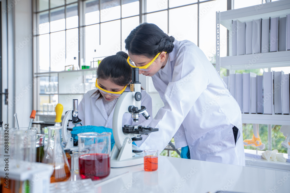 Medical Research and Scientists are working with a microscope and a tablet and Test Tubes, Micropipette and Analysis Results in a laboratory. Medical Research and Scientists are working with a microscope and a tablet and Test Tubes, Micropipette and Analysis Results in a laboratory.