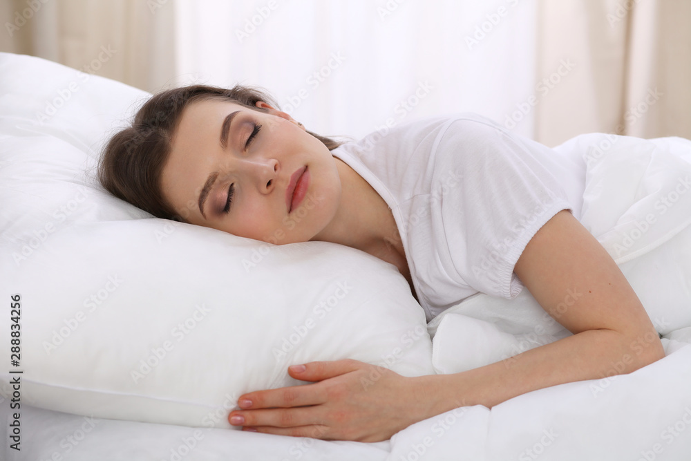 Beautiful young woman sleeping while lying in her bed. Concept of pleasant and rest reinstatement for active life