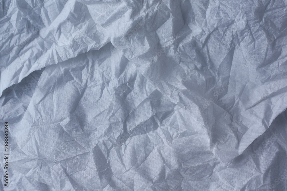 Fototapeta premium The crumpled background of the unfolded white paper