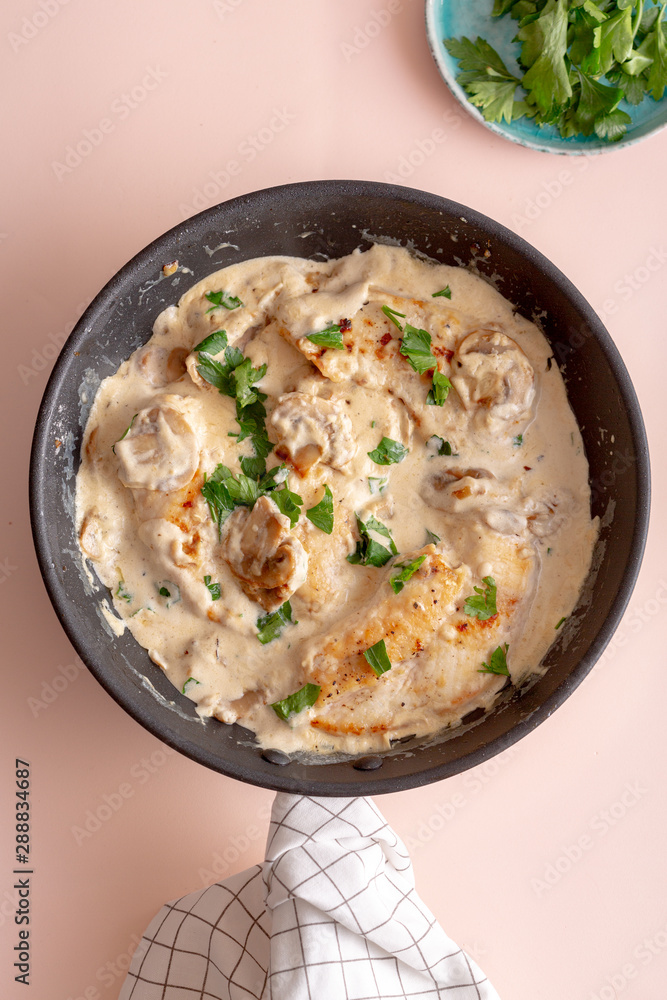 Creamy mushroom chicken in a pan. top view