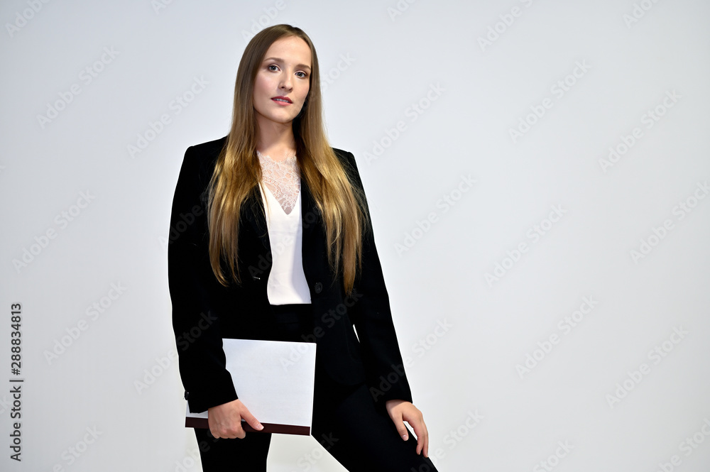 Business photo portrait of a young woman in a business suit on a light background. Well-groomed hair, excellent facial skin. It is in different poses. Business photo portrait of a young woman in a business suit on a light background. Well-groomed hair, excellent facial skin. It is in different poses.