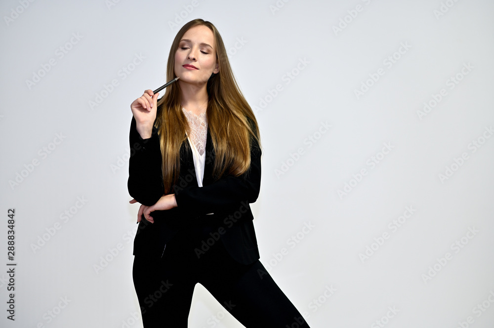 Business photo portrait of a young woman in a business suit on a light background. Well-groomed hair, excellent facial skin. It is in different poses. Business photo portrait of a young woman in a business suit on a light background. Well-groomed hair, excellent facial skin. It is in different poses.