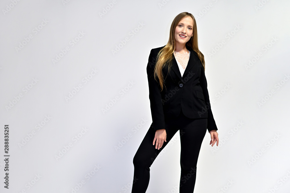 Business photo portrait of a young woman in a business suit on a light background. Well-groomed hair, slim figure. It is in different poses. Business photo portrait of a young woman in a business suit on a light background. Well-groomed hair, slim figure. It is in different poses.