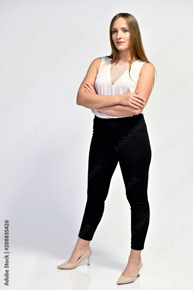 Business photo portrait of a young woman in a business suit on a light background. Well-groomed hair, slim figure. It is in different poses. Business photo portrait of a young woman in a business suit on a light background. Well-groomed hair, slim figure. It is in different poses.