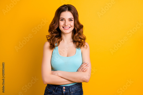 Photo of cheerful cute gorgeous happy smiling trendy wavy girlfriend wearing teal singlet jeans denim isolated with yellow vibrant color background